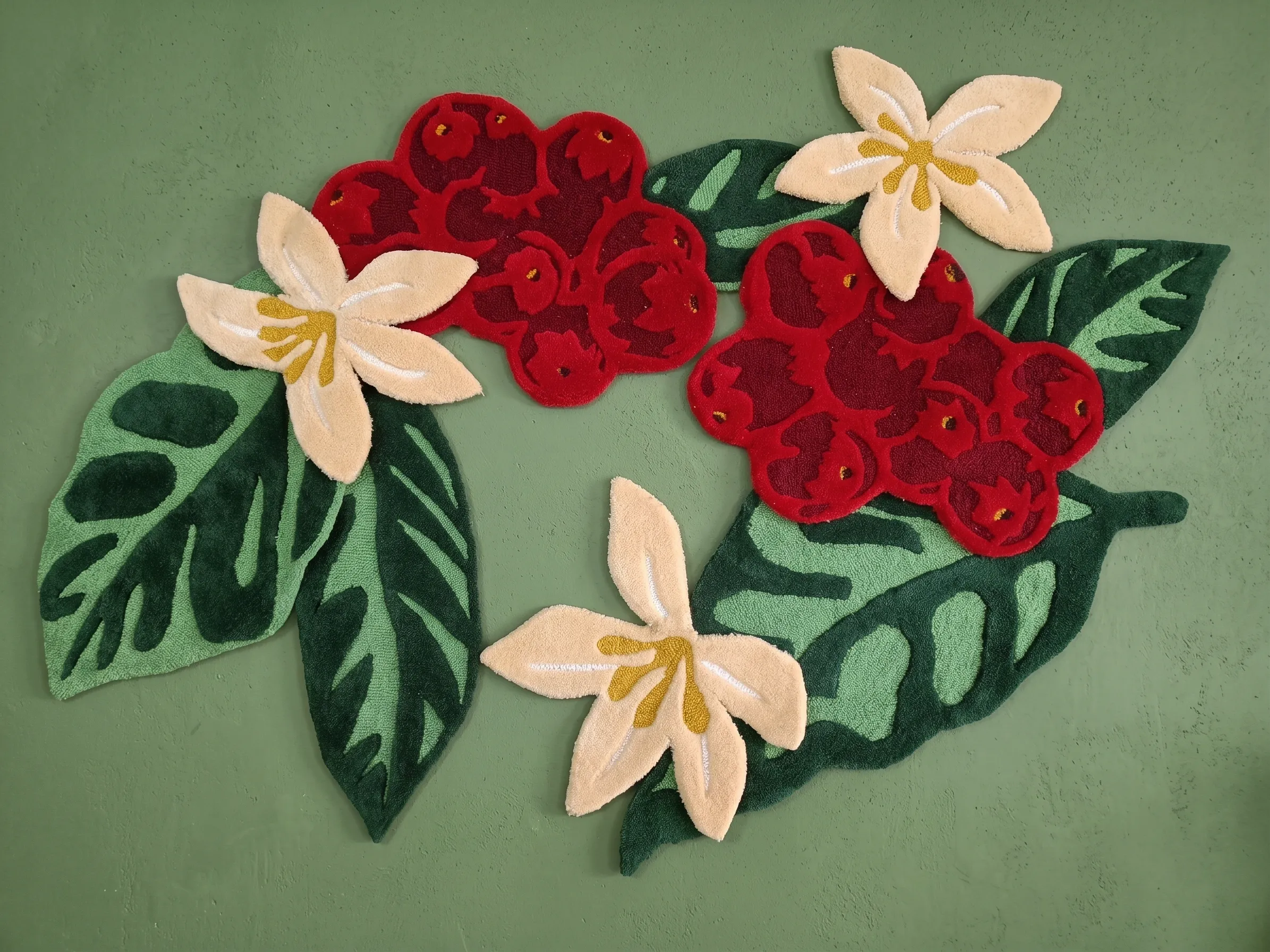 Detail of the hand-tufted woollen coffee cherries, flowers and leaves at Starbucks Rajpur Road, Dehradun